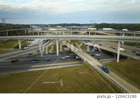 American freeway intersection with fast driving cars and trucks. View from above of USA transportation infrastructure American freeway intersection with fast driving cars and trucks. View from above of USA transportation infrastructure 120423280