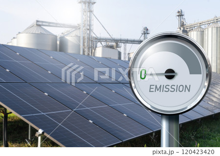 Modern farm using renewable energy. Solar panels with silos in the background. 120423420