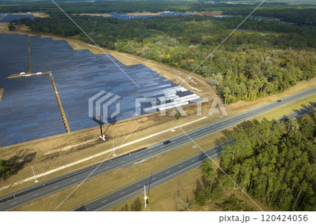 Aerial view of big sustainable electric power plant with many rows of solar photovoltaic panels for producing clean electrical energy. Renewable electricity with zero emission concept Aerial view of big sustainable electric power plant with many rows of solar photovoltaic panels for producing clean electrical energy. Renewable electricity with zero emission concept 120424056