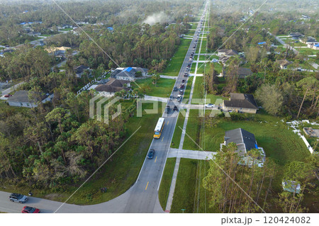 Aerial view of american yellow school bus picking up children at sidewalk bus stop for their lessongs in early morning. Public transportation in the USA Aerial view of american yellow school bus picking up children at sidewalk bus stop for their lessongs in early morning. Public transportation in the USA 120424082