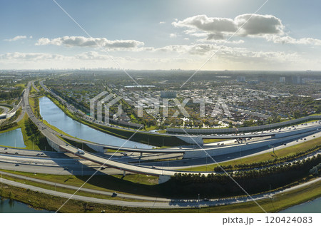 Aerial view of american highway junction with fast driving vehicles in Miami, Florida. View from above of USA transportation infrastructure Aerial view of american highway junction with fast driving vehicles in Miami, Florida. View from above of USA transportation infrastructure 120424083