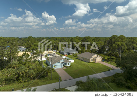 Aerial landscape view of suburban private houses between green palm trees in Florida quiet rural area Aerial landscape view of suburban private houses between green palm trees in Florida quiet rural area 120424093