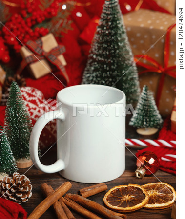 White ceramic coffee mug near Christmas decor, trees, spices and red sweater, mockup 120424694