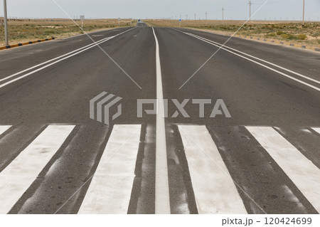 A road with a pedestrian crossing in the foreground. Asphalt road in Kazakhstan. Mangystau Region 120424699