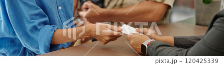 Exchanging Documents at Reception Counter Without Eye Contact 120425339