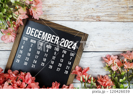 December 2024 monthly calendar with flower bouquet decoration on wooden background December 2024 monthly calendar with flower bouquet decoration on wooden background 120426039