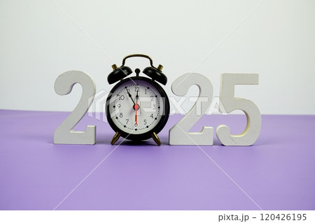 Happy new year 2025 and alarm clock on purple background Happy new year 2025 and alarm clock on purple background 120426195