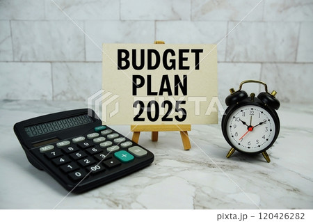 Budget plan 2025 text written on paper card with calculator and alarm clock on marble background 120426282
