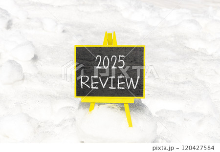 Planning 2025 review new year symbol. Concept words 2025 Review on beautiful yellow chalk blackboard. Beautiful white snow background. Business 2025 review new year concept. Copy space. 120427584