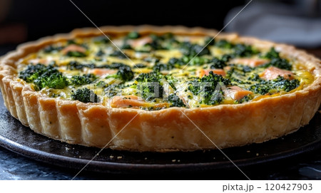 Broccoli and salmon quiche on a dark background, homemade food concept 120427903