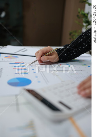 A person is writing on a piece of paper with a pen A person is writing on a piece of paper with a pen 120428320