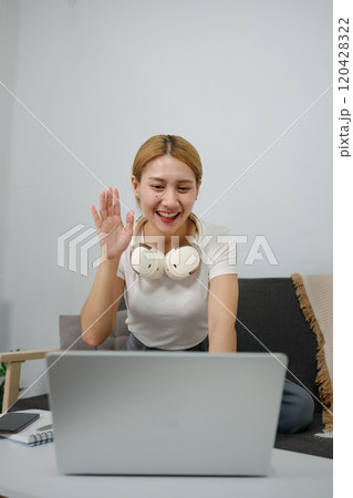 A woman wearing headphones is smiling A woman wearing headphones is smiling 120428322