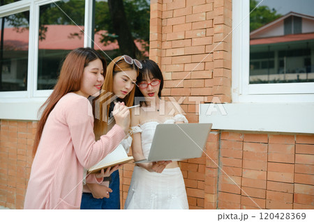 Three women are standing in front of a brick wall Three women are standing in front of a brick wall 120428369