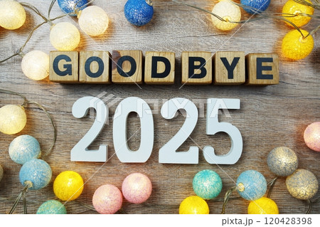 Goodbye 2025 years number with LED cotton balls decoration top view on wooden background 120428398