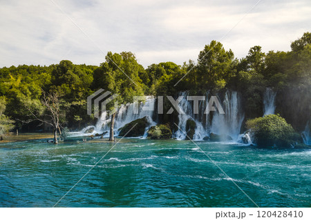 Kravica Waterfall cascade into a vibrant turquoise river in Bosnia and Herzegovina  120428410