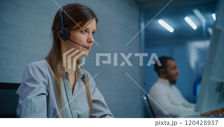 Close up of female technical support specialist in headset providing online customer service Close up of female technical support specialist in headset providing online customer service 120428937