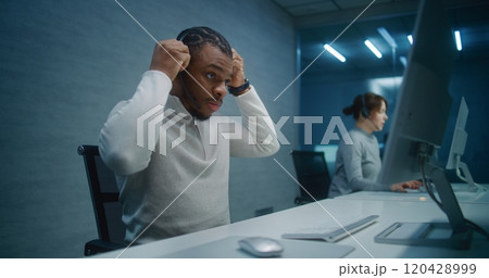 African American hotline operator wears headset, starts night shift in call center African American hotline operator wears headset, starts night shift in call center 120428999