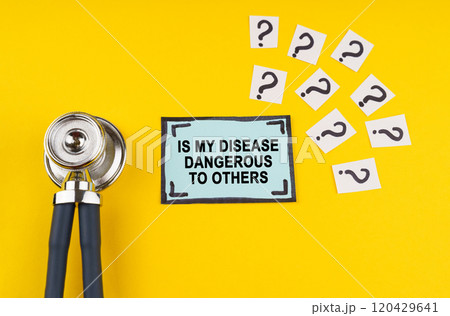 On a yellow background, a stethoscope and a sticker with the inscription - Is my disease dangerous to others 120429641