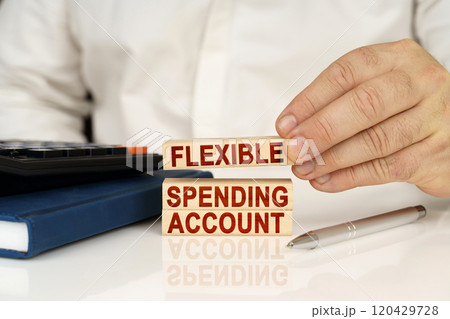 In the hands of a businessman, wooden blocks with the inscription - FLEXIBLE SPENDING ACCOUNT 120429728