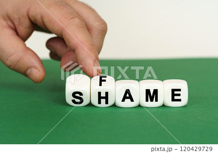 On a green surface are white cubes with the inscription - SHAME or FAME 120429729