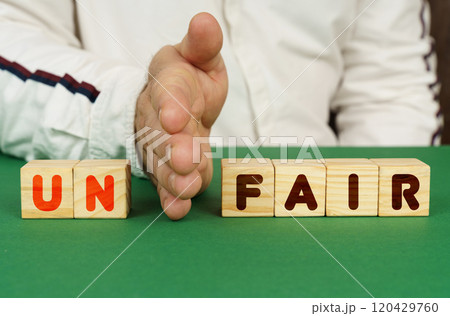 A man separates the cubes with the inscription - UN FAIR 120429760