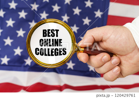 In front of the American flag, a man holds a magnifying glass in his hand with the inscription - Best Online Colleges 120429761