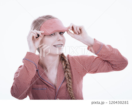 Sleepy woman wearing pink eye band Sleepy woman wearing pink eye band 120430281