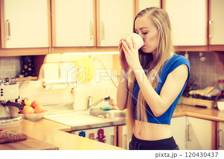 Woman holding cup of tea of coffee 120430437