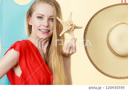 Young woman holding starfish Young woman holding starfish 120430595