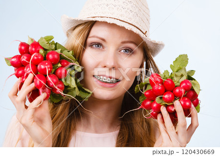 Happy woman giving radish 120430669