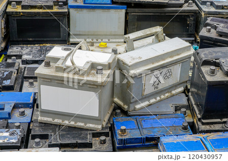 Stack of many used car batteries for recycling in a hazardous waste facility 120430957
