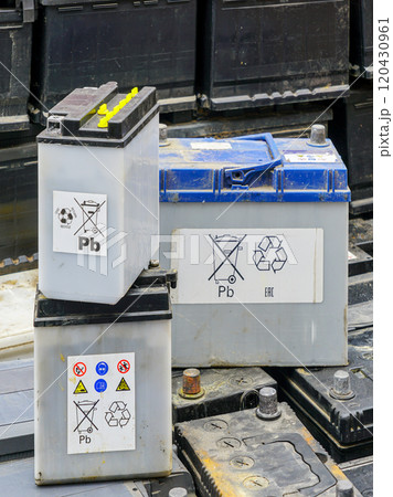 Stack of many used car batteries for recycling in a hazardous waste facility 120430961