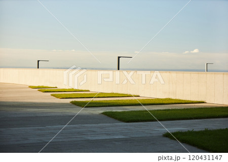 Modern walkway design emphasizing clean, geometric lines and minimalistic lighting features seen in outdoor urban environments Modern walkway design emphasizing clean, geometric lines and minimalistic lighting features seen in outdoor urban environments 120431147