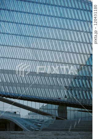 Showcasing innovative architectural design featuring large glass facades and steel structures reflecting contemporary urban setting. Emphasizing clean lines and geometric patterns 120431180
