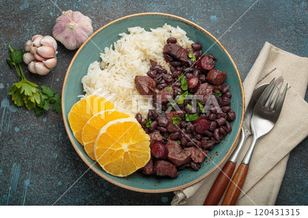 Feijoada, traditional brazilian stew with black beans, rice, and orange slices, top view 120431315