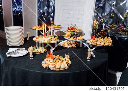Luxury event setup with champagne bottles, flutes, and orange juice on a banquet table 120431805