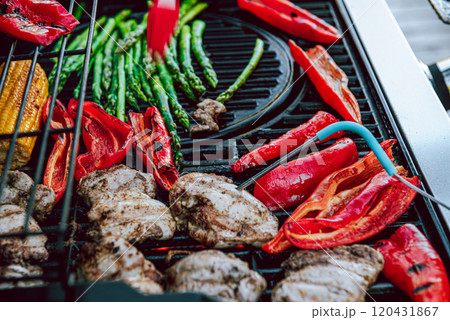 Cooking of meat and vegetables on a grill or on barbeque with temperature check. 120431867