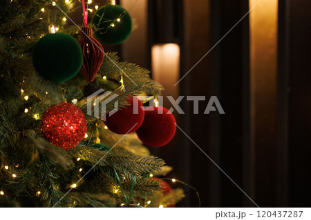 Close-up of a Christmas tree with red balls and bokeh in the background. 120437287