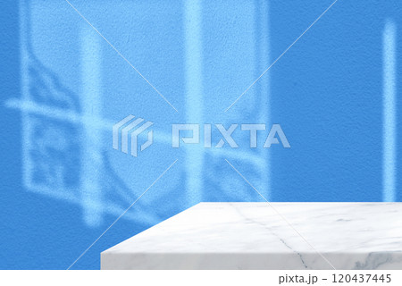 White Marble Table Corner with Light Beam, Shadow, and Spotlight from Vintage Window on the Blue Concrete Wall Background White Marble Table Corner with Light Beam, Shadow, and Spotlight from Vintage Window on the Blue Concrete Wall Background 120437445