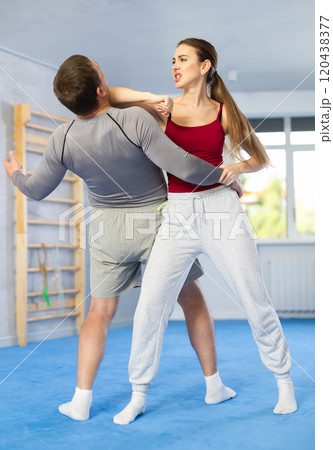 Woman and man practicing self defense techniques 120438377