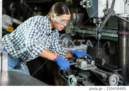 Young woman working with drill machine Young woman working with drill machine 120438480