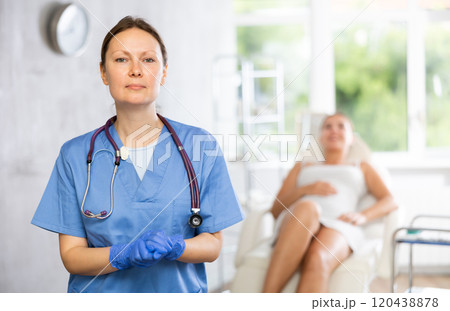 Adult female doctor posing in medical room Adult female doctor posing in medical room 120438878