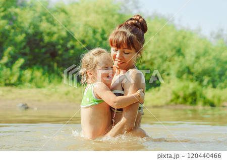 mom and child swim in the river 120440466