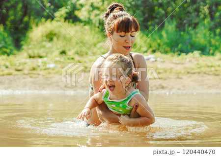 mom and child swim in the river mom and child swim in the river 120440470