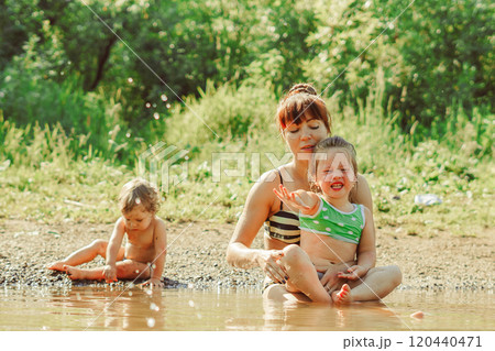 mom and child swim in the river 120440471