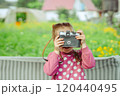 A little girl with a camera 120440495