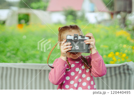 A little girl with a camera 120440495