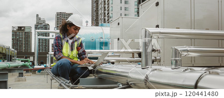 Engineers use laptop for check and look at draft plan of building on constructing site. Engineer working on building site. Engineer working with drawing System plan document 120441480