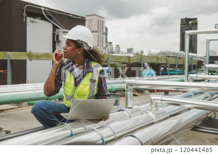 Engineers use laptop for check and look at draft plan of building on constructing site. Engineer working on building site. Engineer working with drawing System plan document Engineers use laptop for check and look at draft plan of building on constructing site. Engineer working on building site. Engineer working with drawing System plan document 120441485
