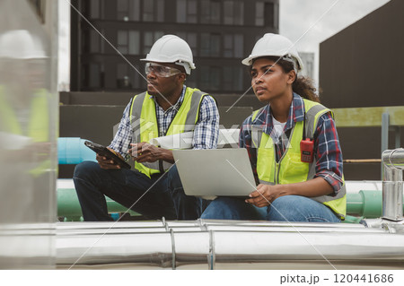 Team Engineers with draft plan of building on constructing site. Engineer work on site. engineer visit and inspection site engineer. Inspector engineer check and working on site. 120441686